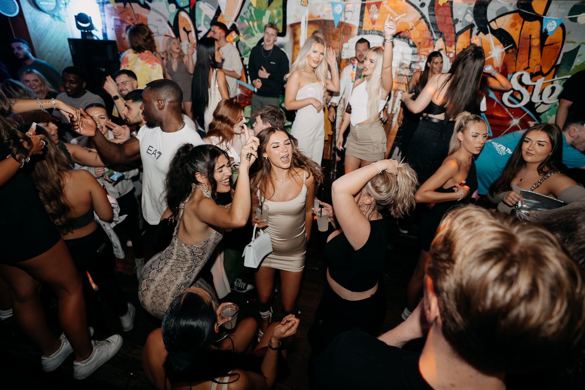 A full dancefloor beside the painted walls at STEINS